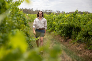 Lachie walking through vineyards