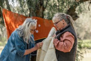 Lady looks closely at possum skin cloak