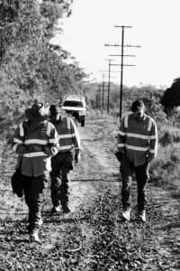 black and white image of people walking doing a cultural heritage assessment