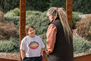 A young person looks up to the Aboriginal Elder on tour