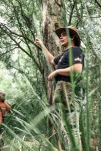 Jonah standing on Country amongst the reeds